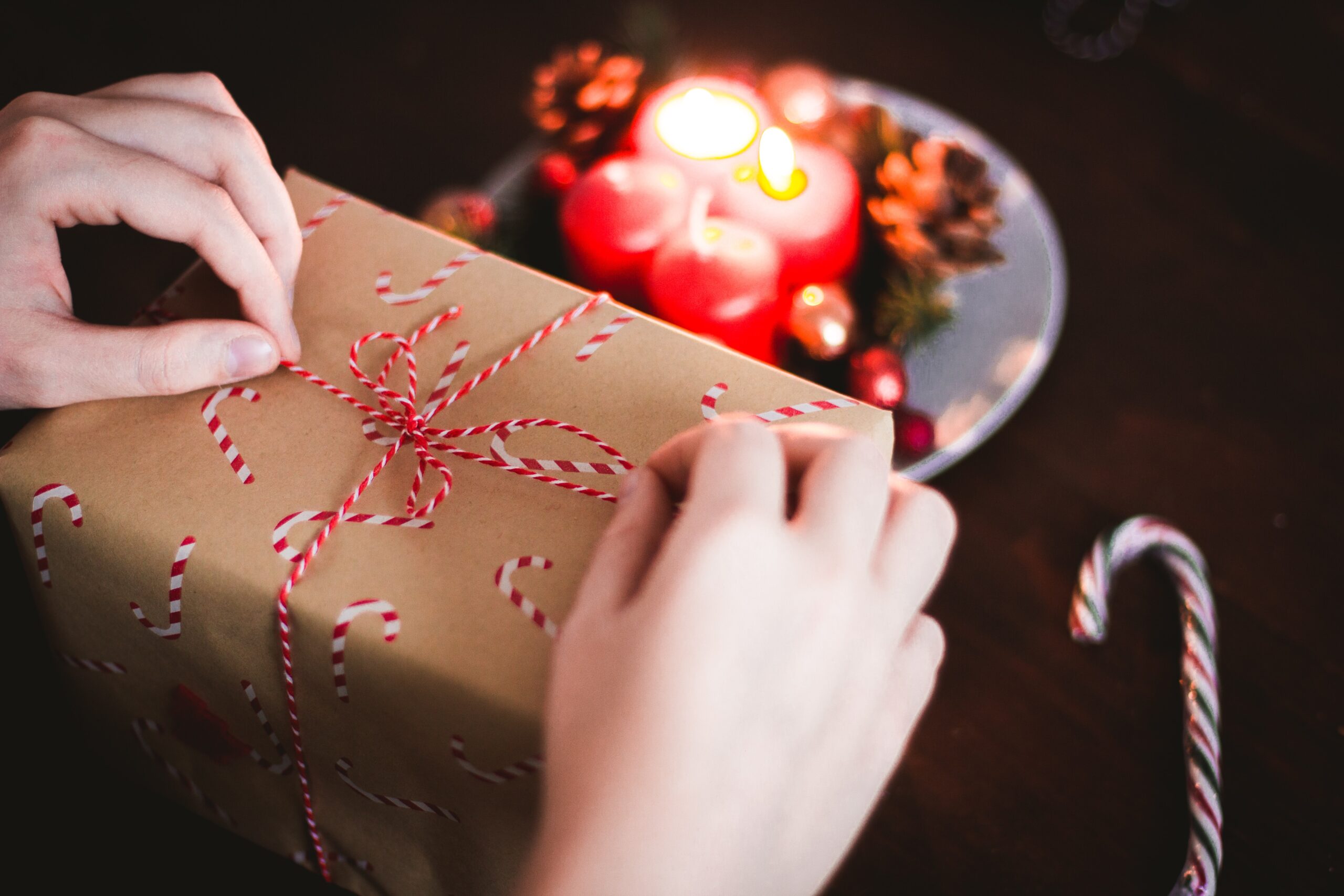 Hands wrapping a holiday gift